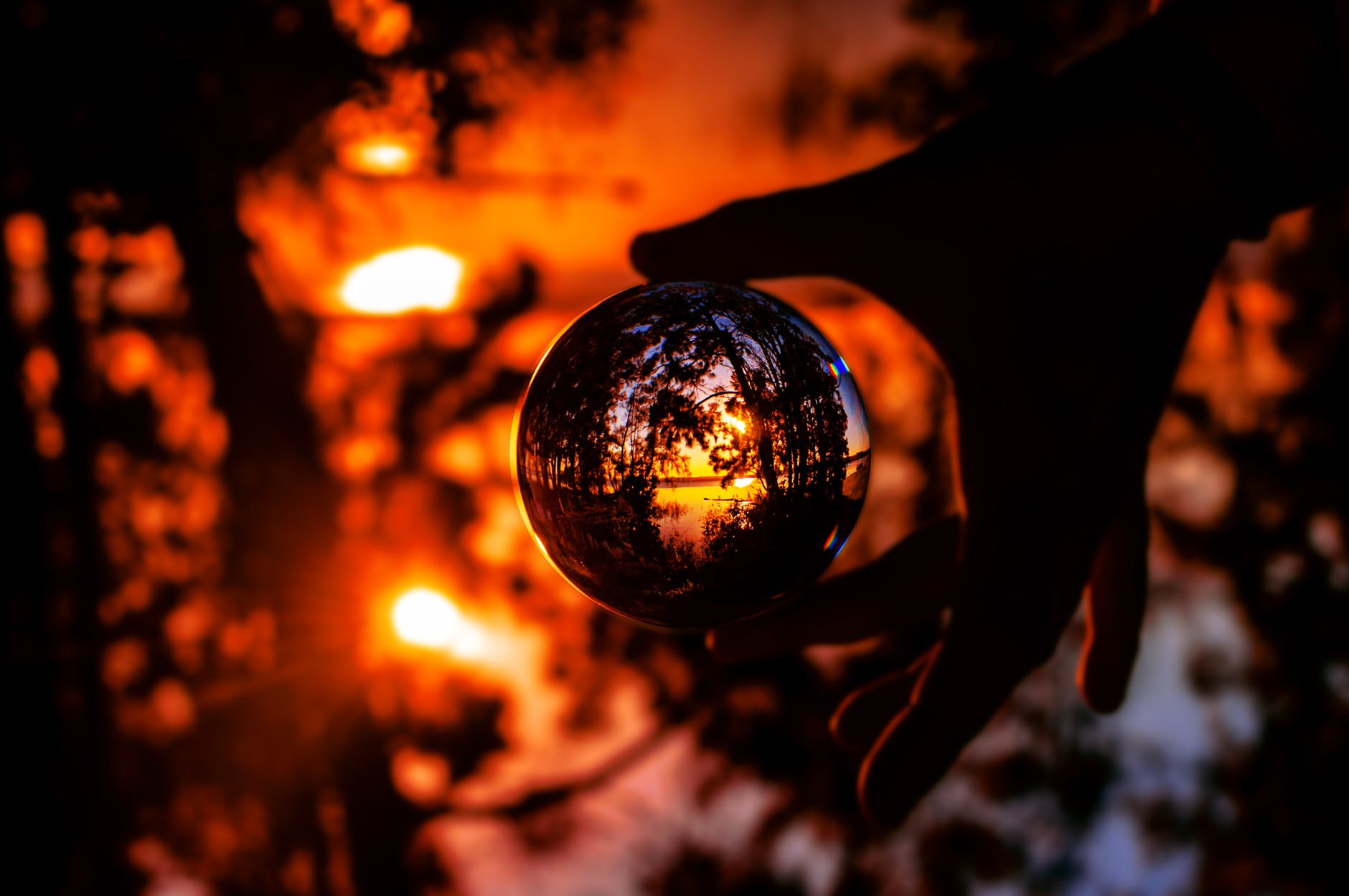 photo of person s hand holding a lensball