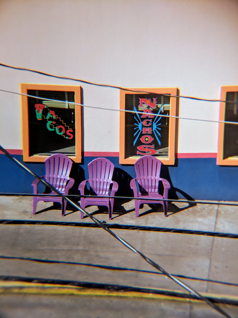 three purple plastic chairs